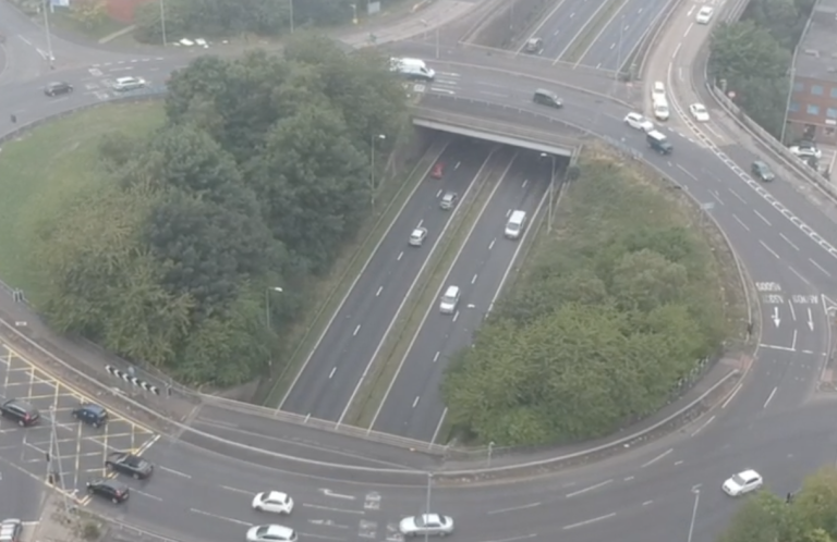 Basford Roundabout Aerial view of a Basford roundabout with cars and greenery around it.