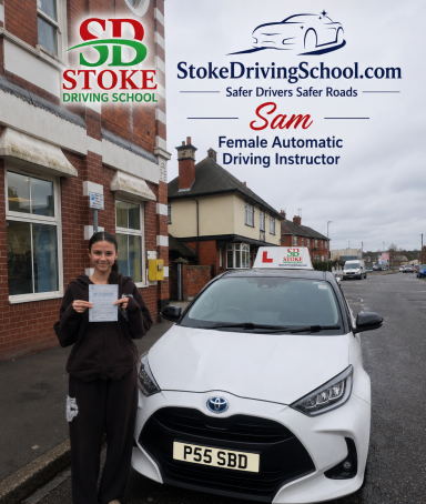 A woman holds a certificate next to a car with a driving school sign outside a building.