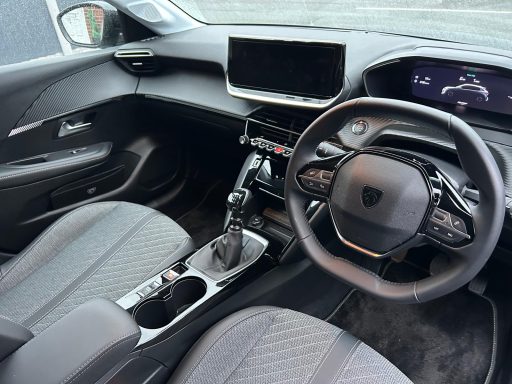 Interior view of a modern car with a sleek dashboard and gear shift.